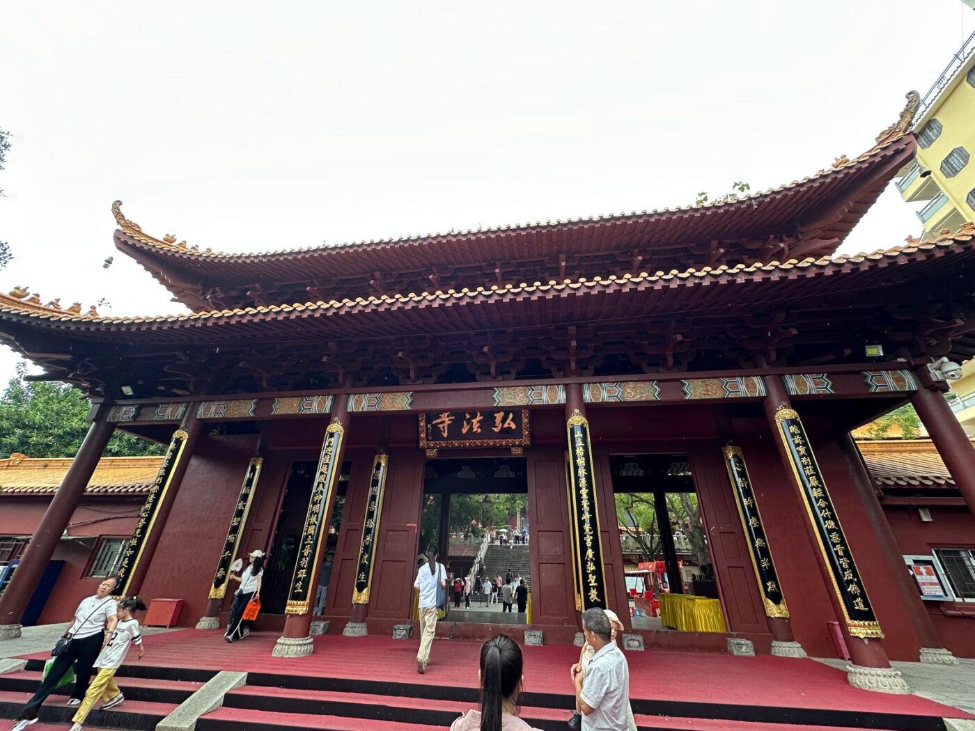 China - From Still Streets to a City That Never Ends 4 tempel This gives a view on the red Hongfa temple with a few people around it.