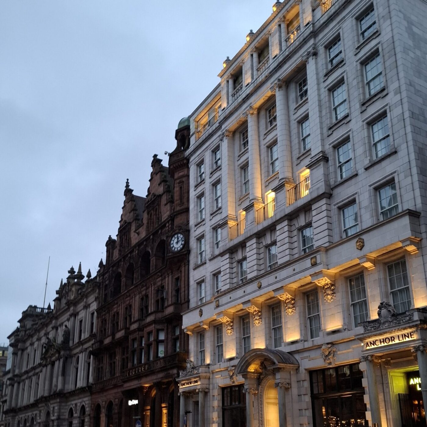 I went to Scotland and became my own best friend 1 20250215 171204 View from St. Vincent Pl., Glasgow in February, it's slowly getting dark, the lights on a white building are on