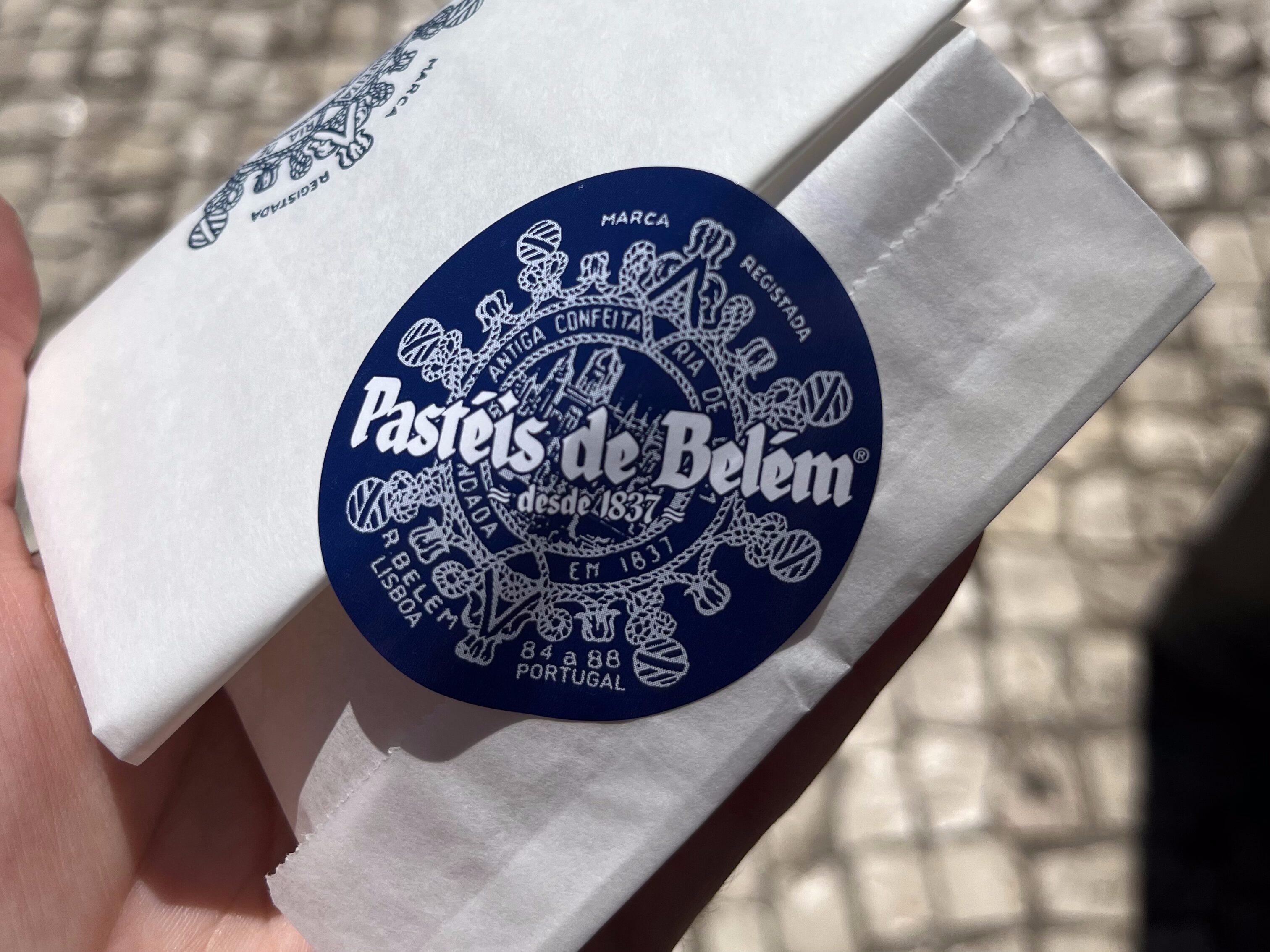 Saudade: The Feeling I Carried Home from Portugal 8 IMG 0126 Pastéis de Belém packaging in my hand.