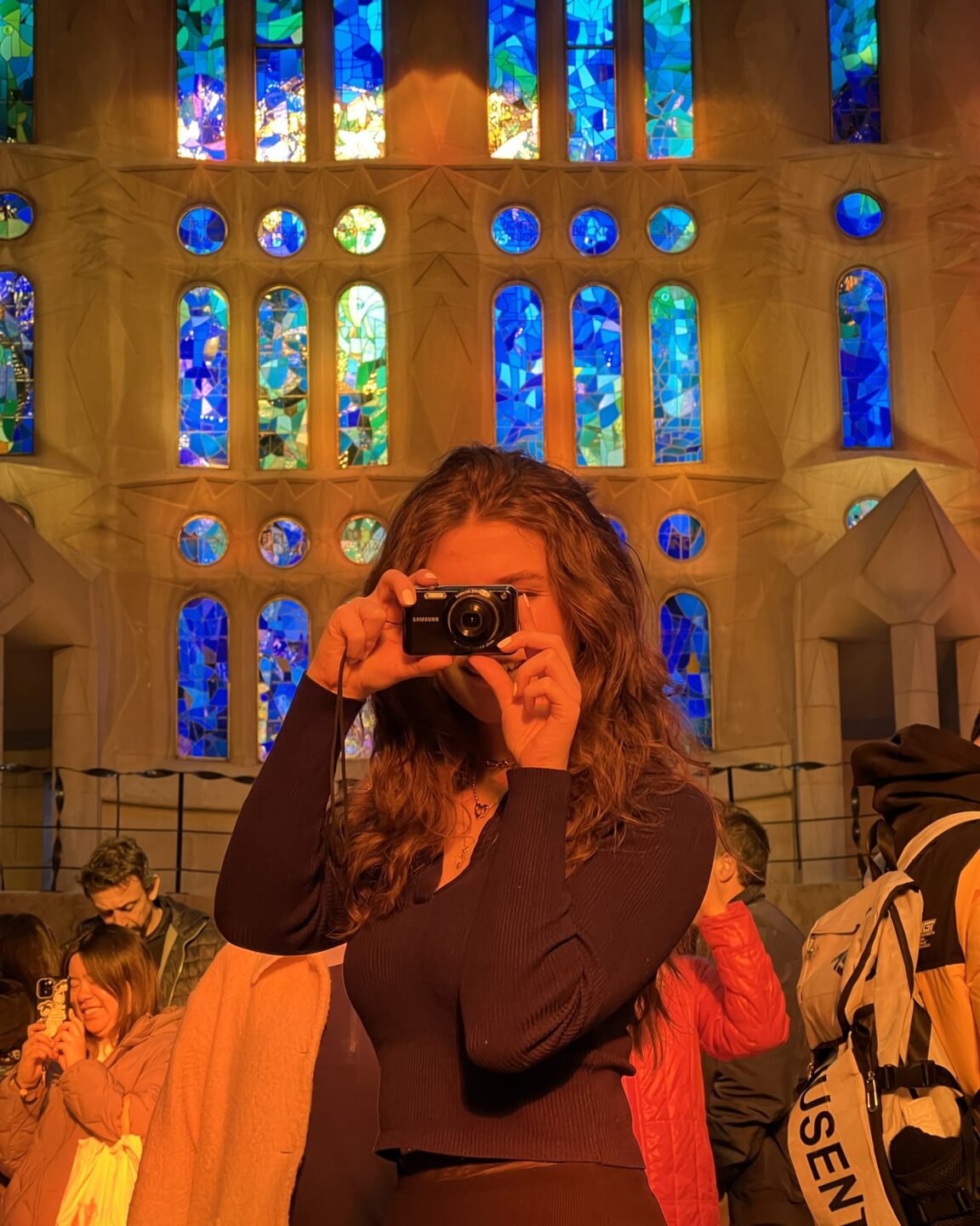 Caught in Between: How I became Part of a Conflict that was never mine 18 IMG 4290 1 A photo of me in the Sagrada Familia with my camera in front of my face, just happy to be there.