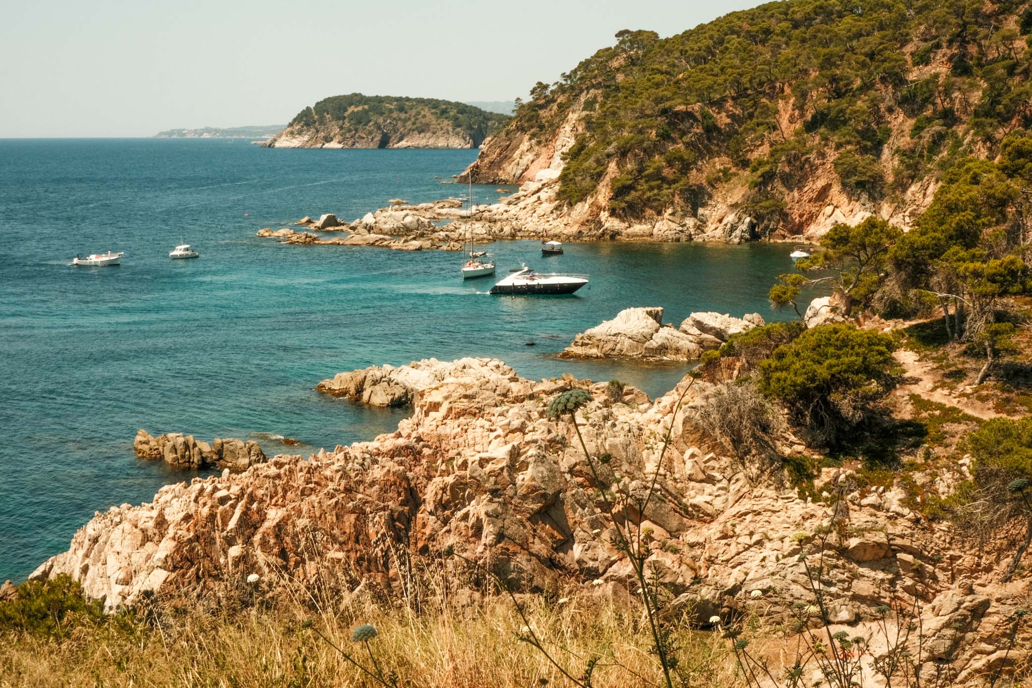 "Living La Vida Loca" in Barcelona 7 IMG 8232 Coastal scene with rocky shore and several boats in the water.