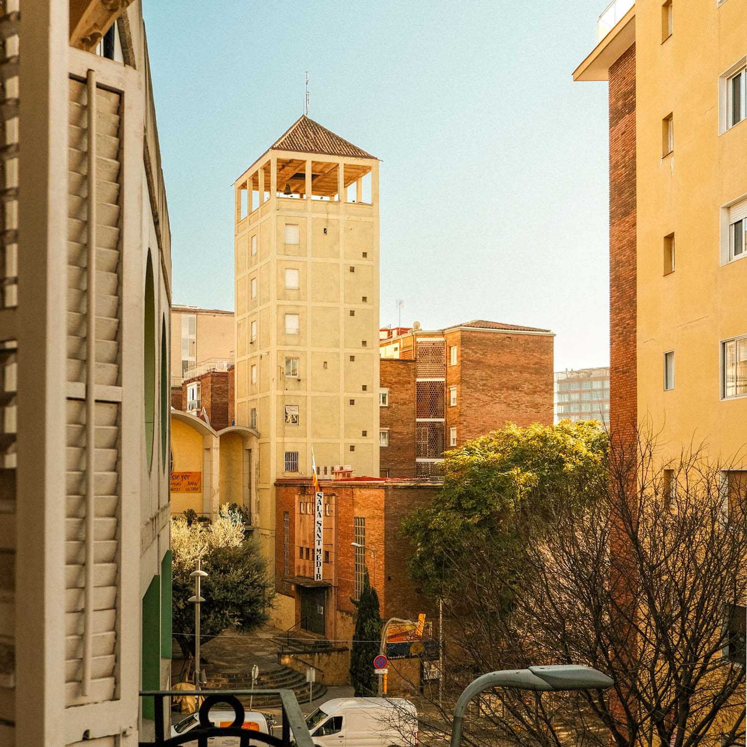 "Living La Vida Loca" in Barcelona 4 IMG 8907 View between residential buildings of a tall yellow tower.