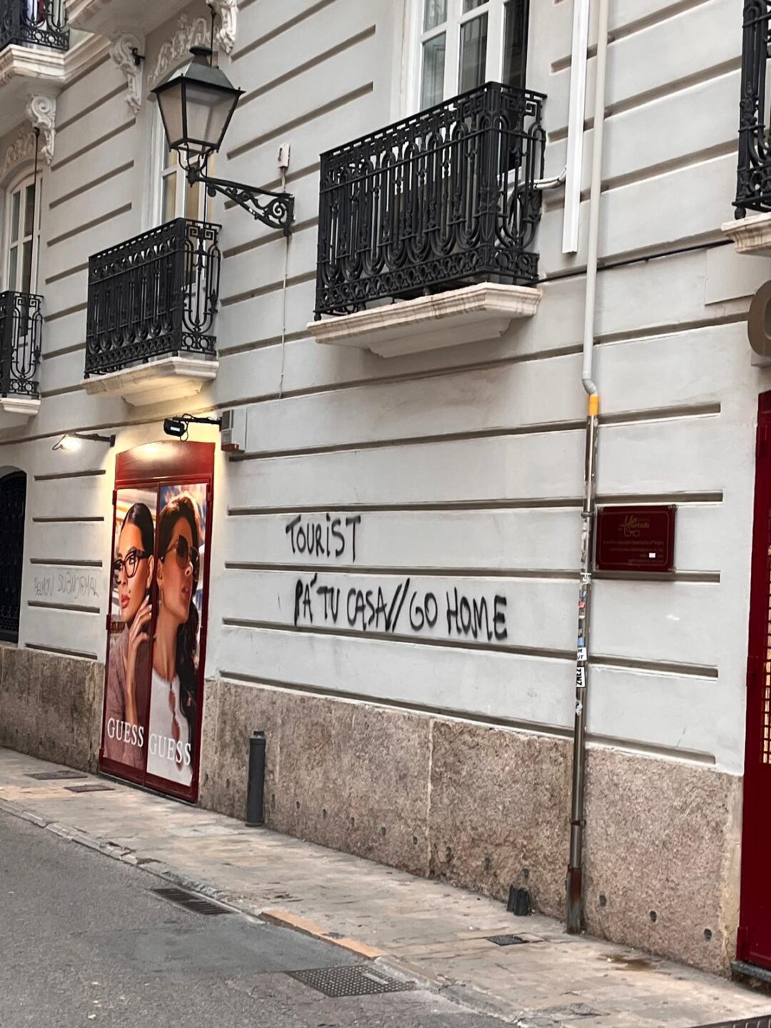 Caught in Between: How I became Part of a Conflict that was never mine 7 tourists bild 2 wall graffiti with “tourists go home” on a house wall in Barcelona