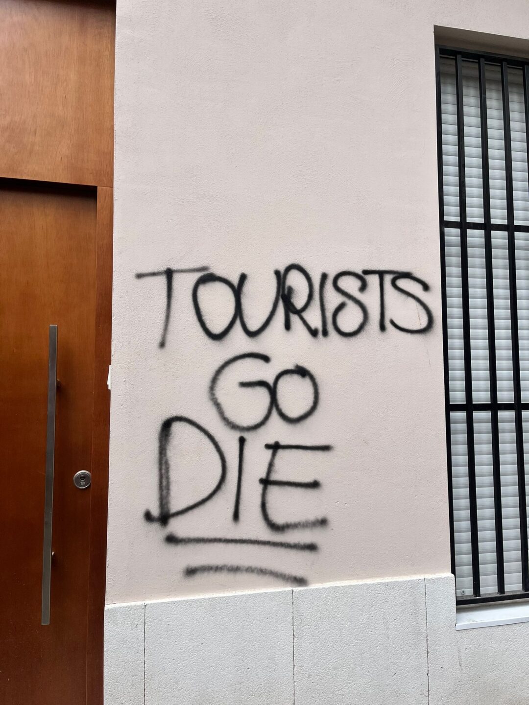 Caught in Between: How I became Part of a Conflict that was never mine 6 tourists bild wall graffiti with “tourists go die” on a house wall in Barcelona